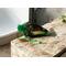 A green sachet of Nana's Apple Pie potpourri sits on a marble countertop filling your surroundings a with nostalgic, spiced apple fragrance.